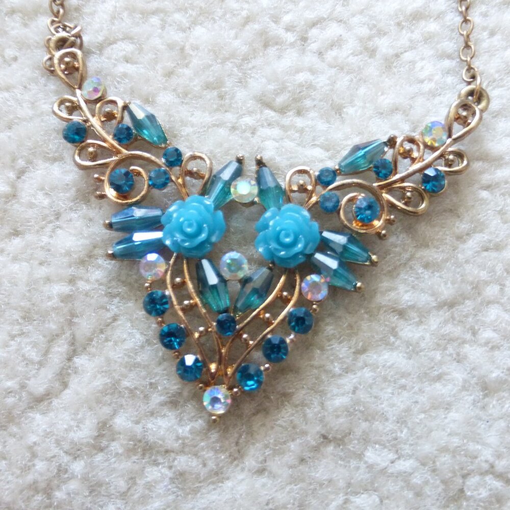Gold and blue statement necklace with blue flowers and rhinestones